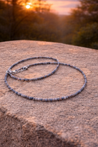 Faceted sapphire natural stone crystal energy necklace with 2mm beads, showcasing blue gemstones on a delicate chain.