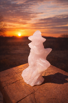Pink Calcite stone witch carving with detailed features, crafted by Practical Magic Store, showcasing a mystical, handcrafted sculpture.