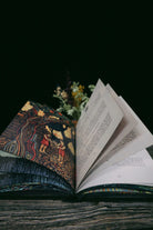 Open Prisma Visions book titled "The Big Visions Book" showcasing colorful illustrated pages on a wooden table.