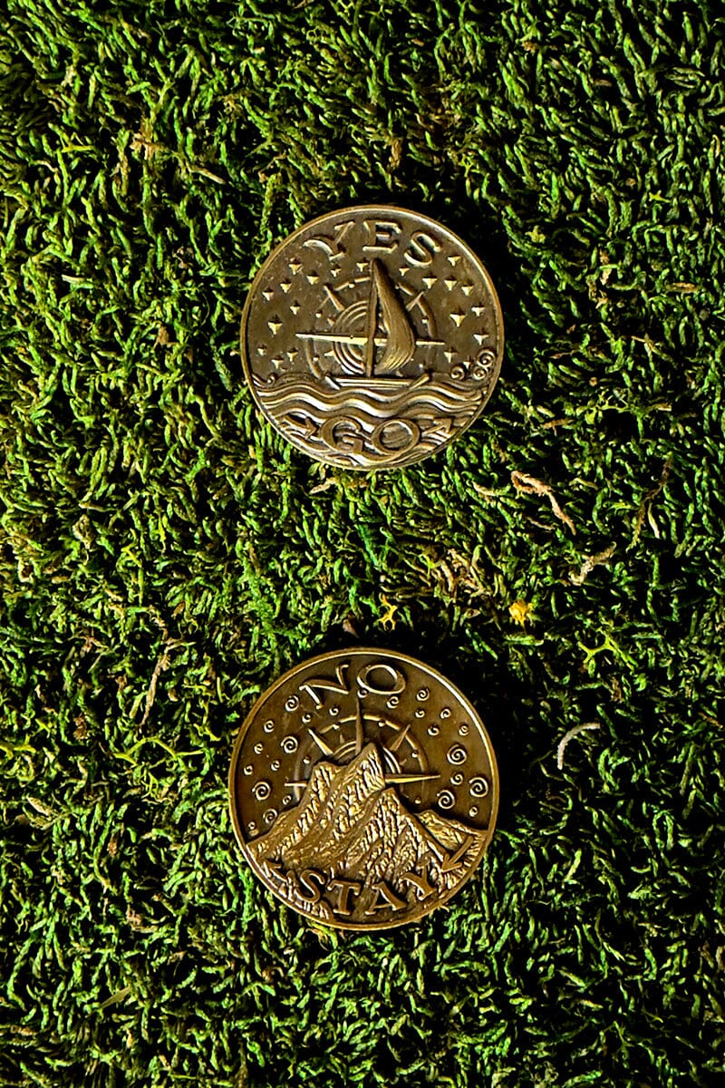 Prisma Visions Coin of Decisions, a round metal coin with engraved designs, symbolizing choices and decision-making.