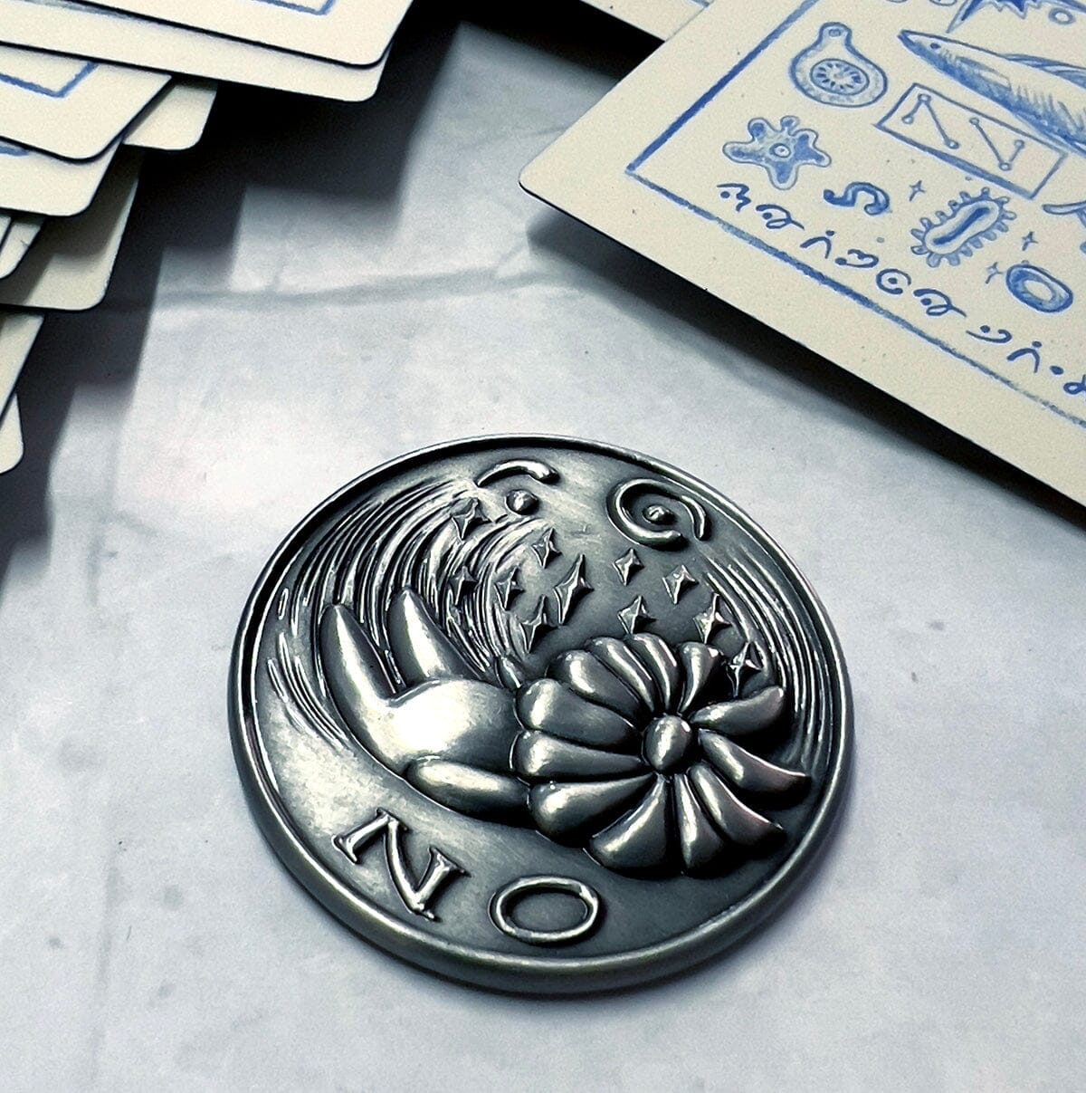 Prisma Visions Kuzo Yes/No coin featuring a circular design with yes and no options for decision-making.