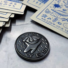 Prisma Visions Kuzo Yes/No Coin featuring a metallic design with engraved Yes and No symbols on its surface.