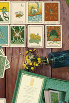 Green Glyphs Tarot deck by Prisma Visions featuring intricate green and black illustrated cards with mystical symbols.