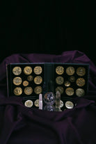Set of 20 Prisma Visions geomancy coins with intricate symbols, used for divination and spiritual practices.