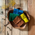 Green Glyphs Satchel by Prisma Visions featuring a vibrant blue and green tarot-inspired design with sturdy leather accents.