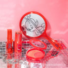 Profusion Cosmetics Hot Stuff The Little Devil handheld mirror with red handle and decorative devil design, perfect accessories for makeup.