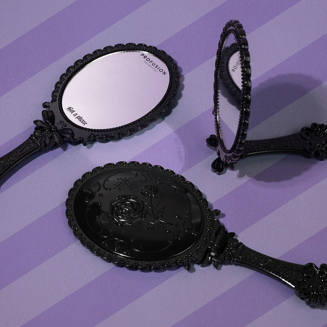 Profusion Cosmetics Not A Phase handheld mirror, a stylish accessories item with a sleek reflective surface.