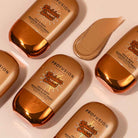 Profusion Cosmetics Golden Coast Face & Body Bronzing Glow Drops showing a dropper and shimmering liquid for a radiant glow.