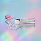 Profusion Cosmetics Dewy Glow Plumping Water Gloss showing a clear, shiny lip gloss tube with a glossy finish.