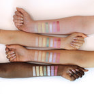 Wanderlust eyeshadow palette by Profusion Cosmetics featuring colorful shades in a sleek compact for creative eye looks.