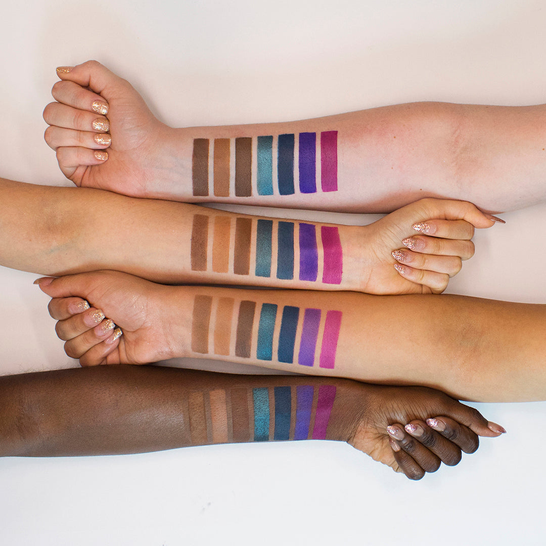 Wanderlust eyeshadow palette by Profusion Cosmetics with colorful shimmery and matte shades in a sleek compact.