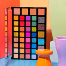 Colorful kaleidoscope eyeshadow look created with Profusion Cosmetics eyeshadow palette featuring vibrant, swirling shades.
