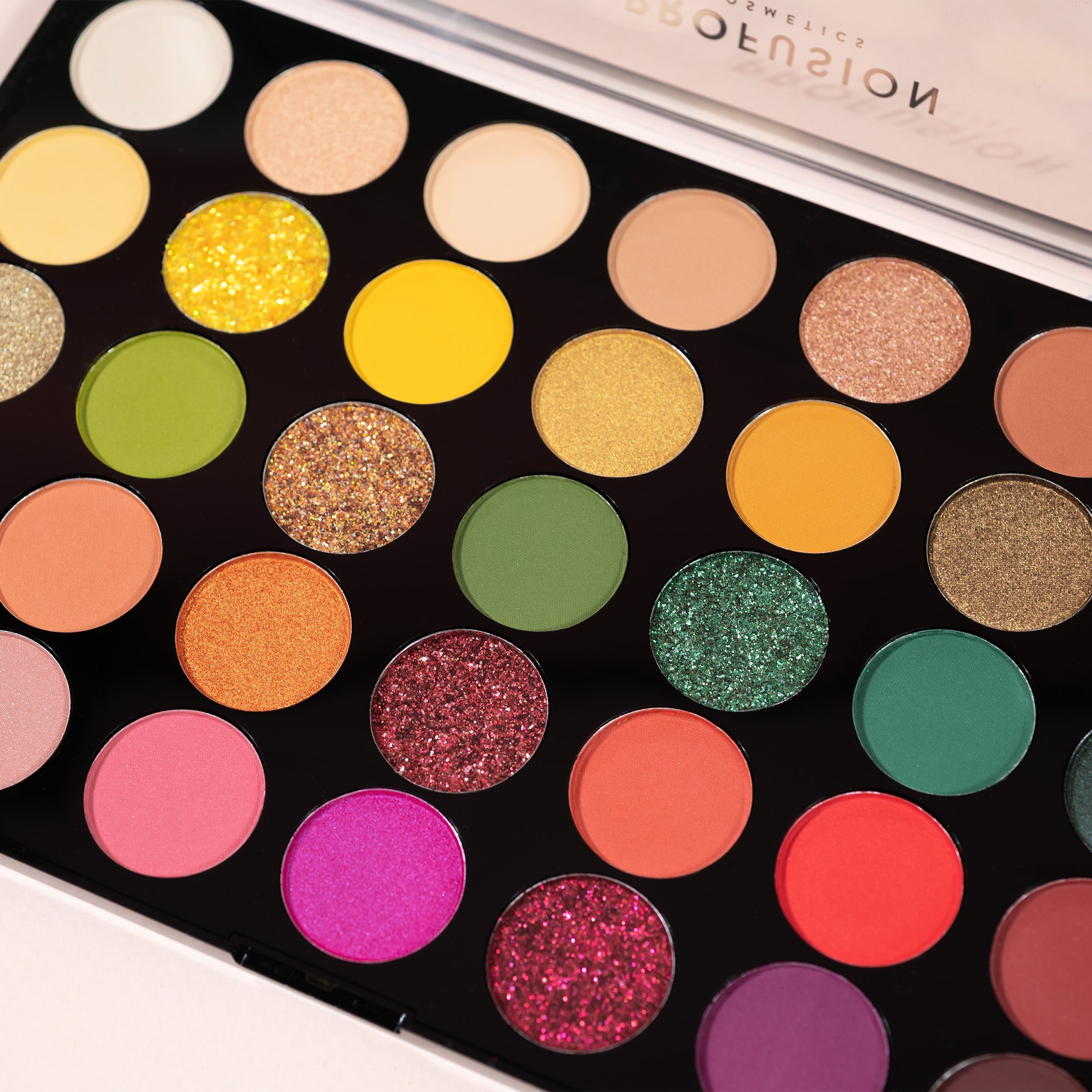 Profusion Cosmetics Marigold eyeshadow palette with vibrant orange and gold shades in a sleek compact.