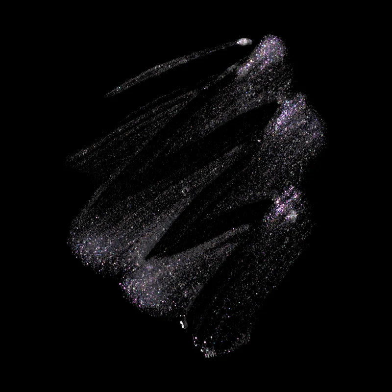 Profusion Cosmetics Metachrome Glitter Glitch Holo Brow Gel and Gems on eyes with shimmering, colorful holographic effect.
