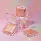 Profusion Cosmetics Holo Beam holographic highlighter on face, showcasing its shiny, iridescent finish for a luminous glow.