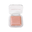 Profusion Cosmetics Holo Beam holographic highlighter on face, showcasing its radiant, shimmering glow for a luminous look.