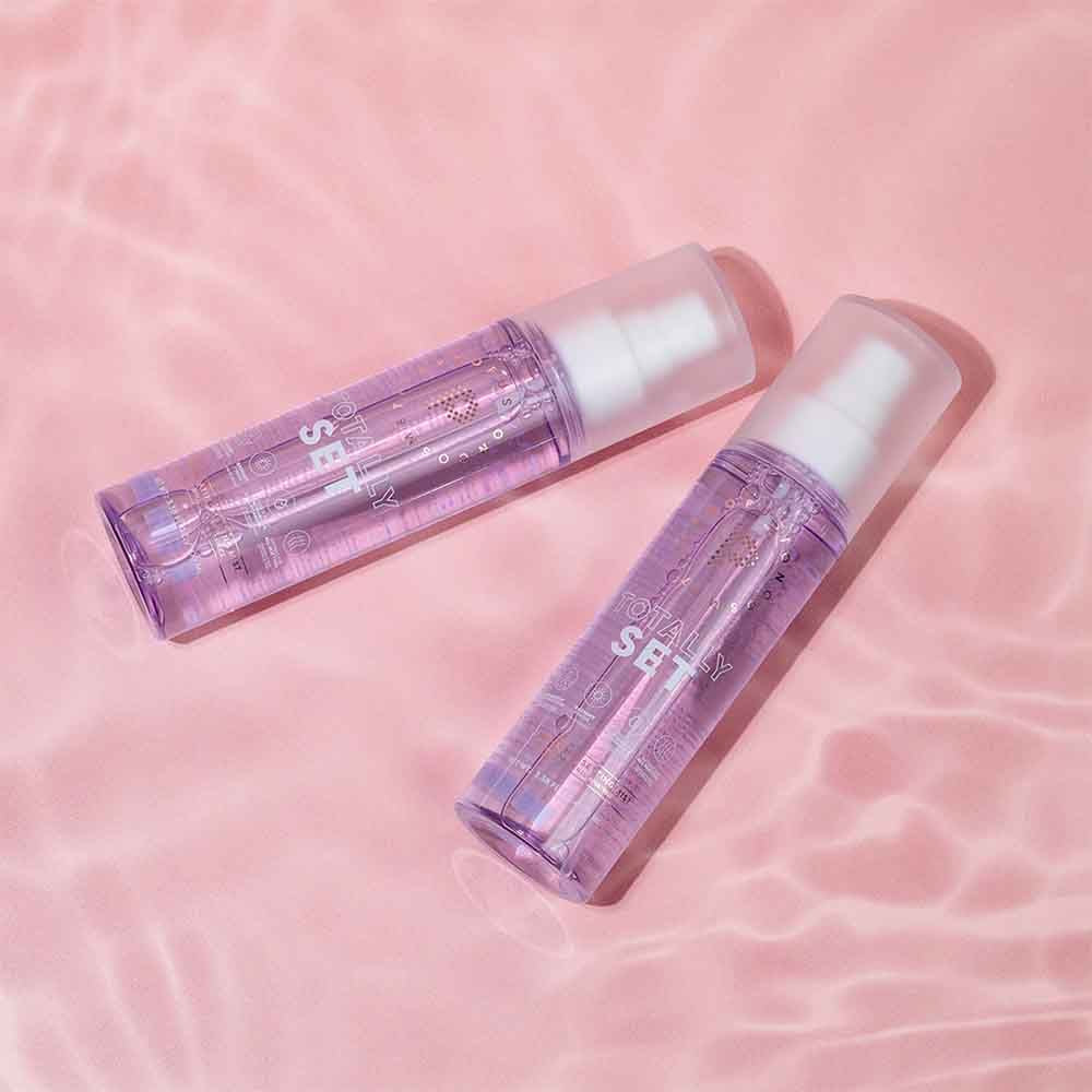 Profusion Cosmetics Totally Set Illuminating Setting Mist spray for face with a clear, sleek bottle and fine mist nozzle.
