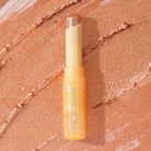 Profusion Cosmetics Jelly Beam Jelly Shimmer Stick for face, featuring a shimmering, jelly-textured highlighter on a neutral background.