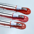 Profusion Cosmetics Frosted Kiss Cooling Plumping Lip Gloss in icy nude shade, shown with smooth, glossy finish on lips.