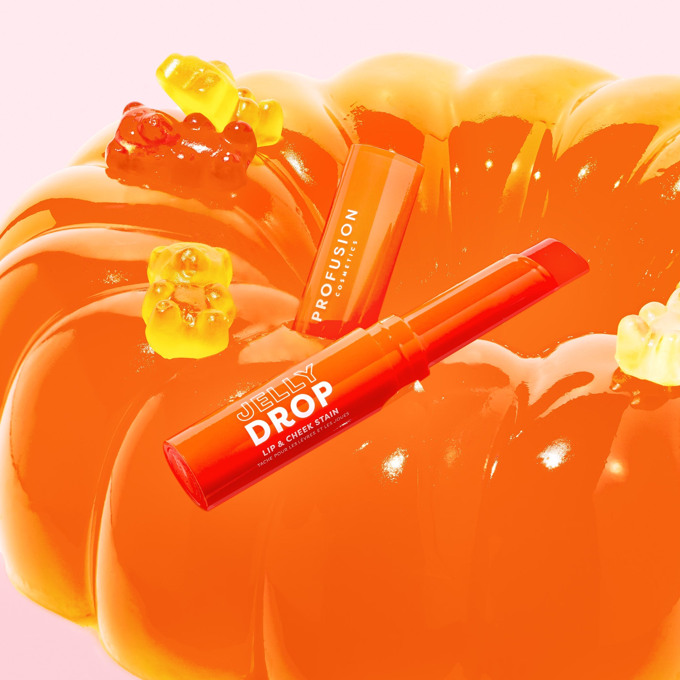 Profusion Cosmetics Jelly Drop Lip & Cheek Stain in Coral Crush, showing the vibrant, glossy lip and cheek application.