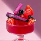 Profusion Cosmetics Jelly Drop Lip & Cheek Stain in Coral Crush, showing the vibrant, glossy stain on lips and cheeks