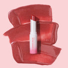 Profusion Cosmetics Glimmer Balm hydrating melting lip balm in coral, showing a smooth, glossy lip with a shimmering finish.