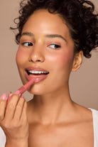 Profusion Cosmetics Dreamy Lip Plump in a cozy nude shade, showcasing smooth, full lips with a glossy finish.