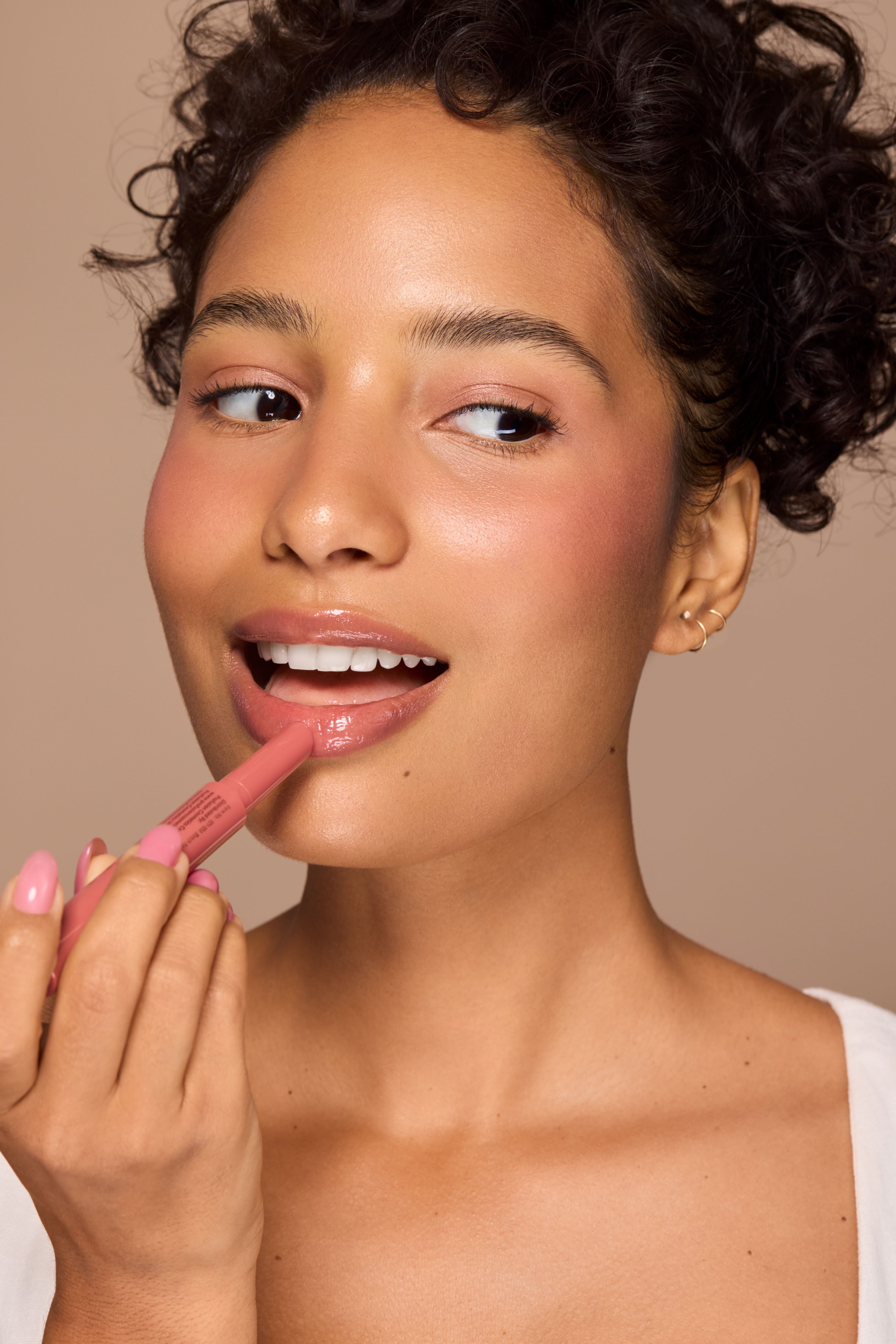 Profusion Cosmetics Dreamy Lip Plump in a cozy nude shade, showcasing smooth, full lips with a glossy finish.