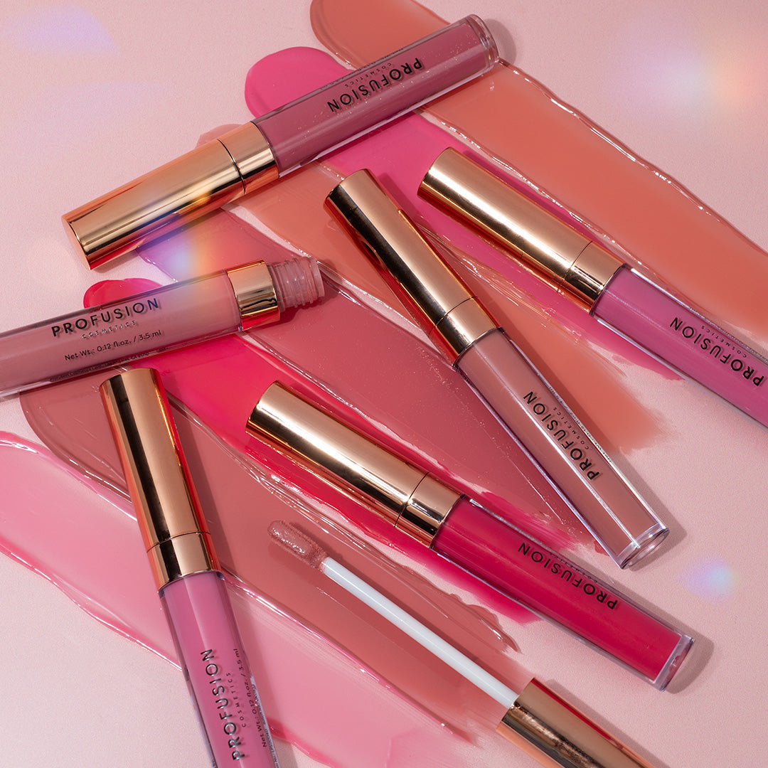 Profusion Cosmetics glossy lip gloss set with six vibrant lip glosses, showcasing shiny, colorful lips in a natural pose.