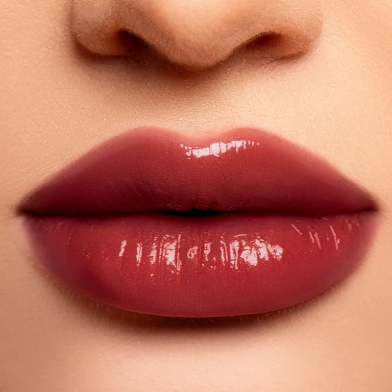 Profusion Cosmetics hydrating liquid lip gloss on lips, smooth and shiny with a natural finish.