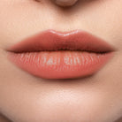 Profusion Cosmetics Lip Glaze Hydrating Lip Stain on lips with a glossy, natural finish in a warm shade.