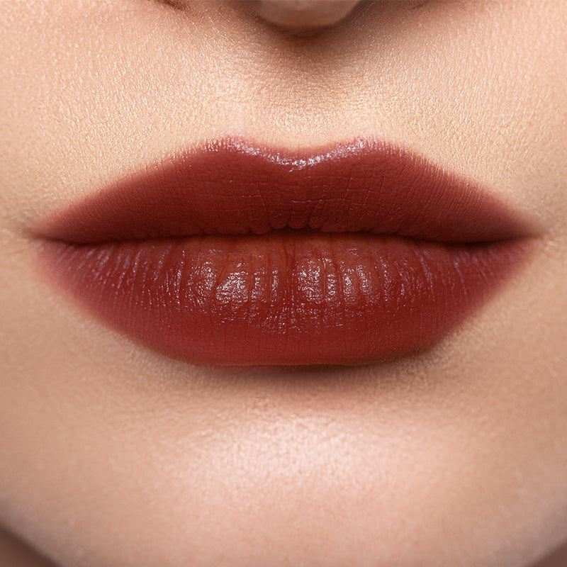 Profusion Cosmetics Lip Glaze Hydrating Lip Stain applied on lips with a glossy finish and warm maple hue.