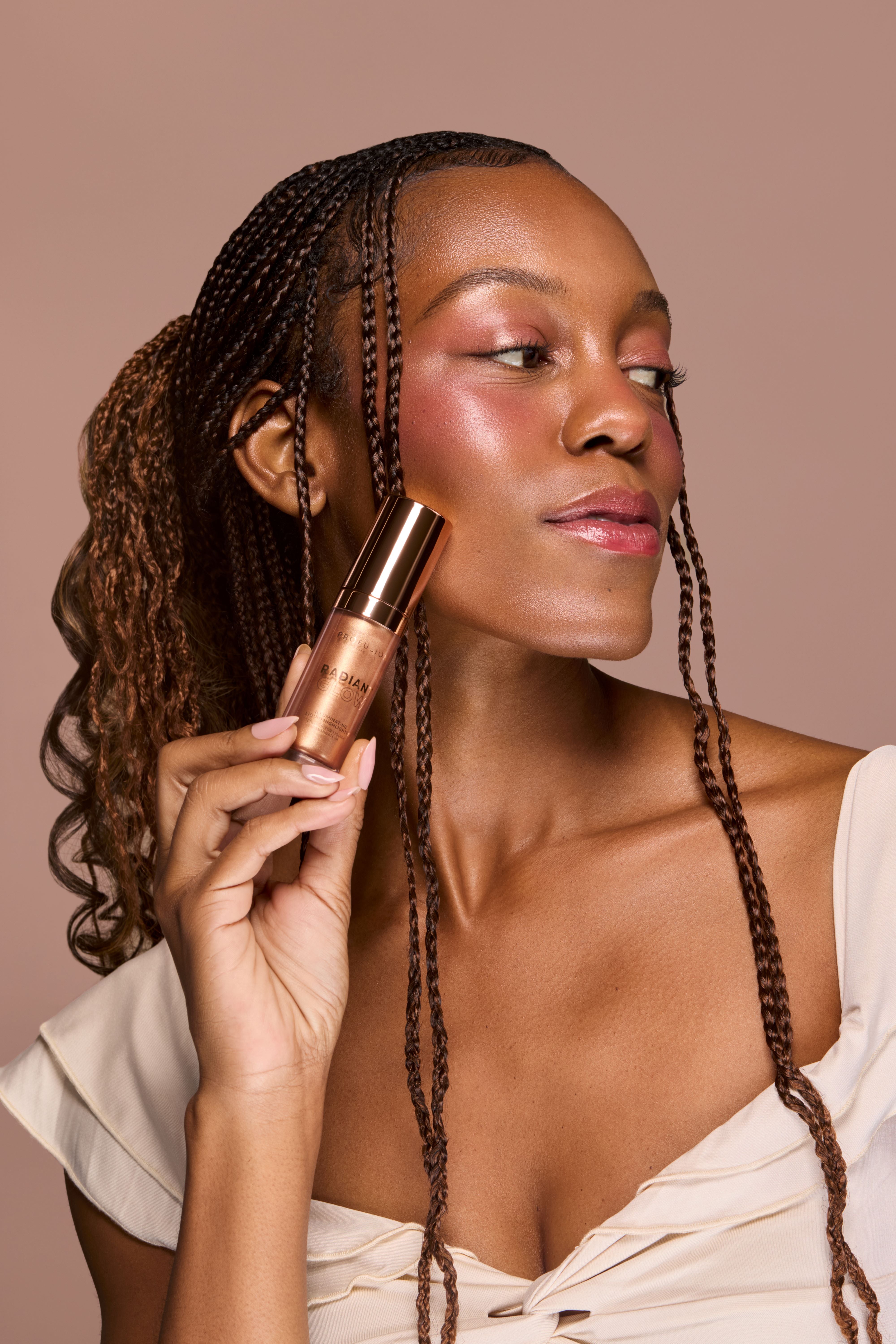 Profusion Cosmetics Radiant Glow Illuminating Liquid Highlighter in champagne shade, showcasing its smooth liquid texture and luminous finish.