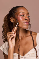 Profusion Cosmetics Radiant Glow Illuminating Liquid Highlighter in champagne shade, showcasing its smooth liquid texture and luminous finish.