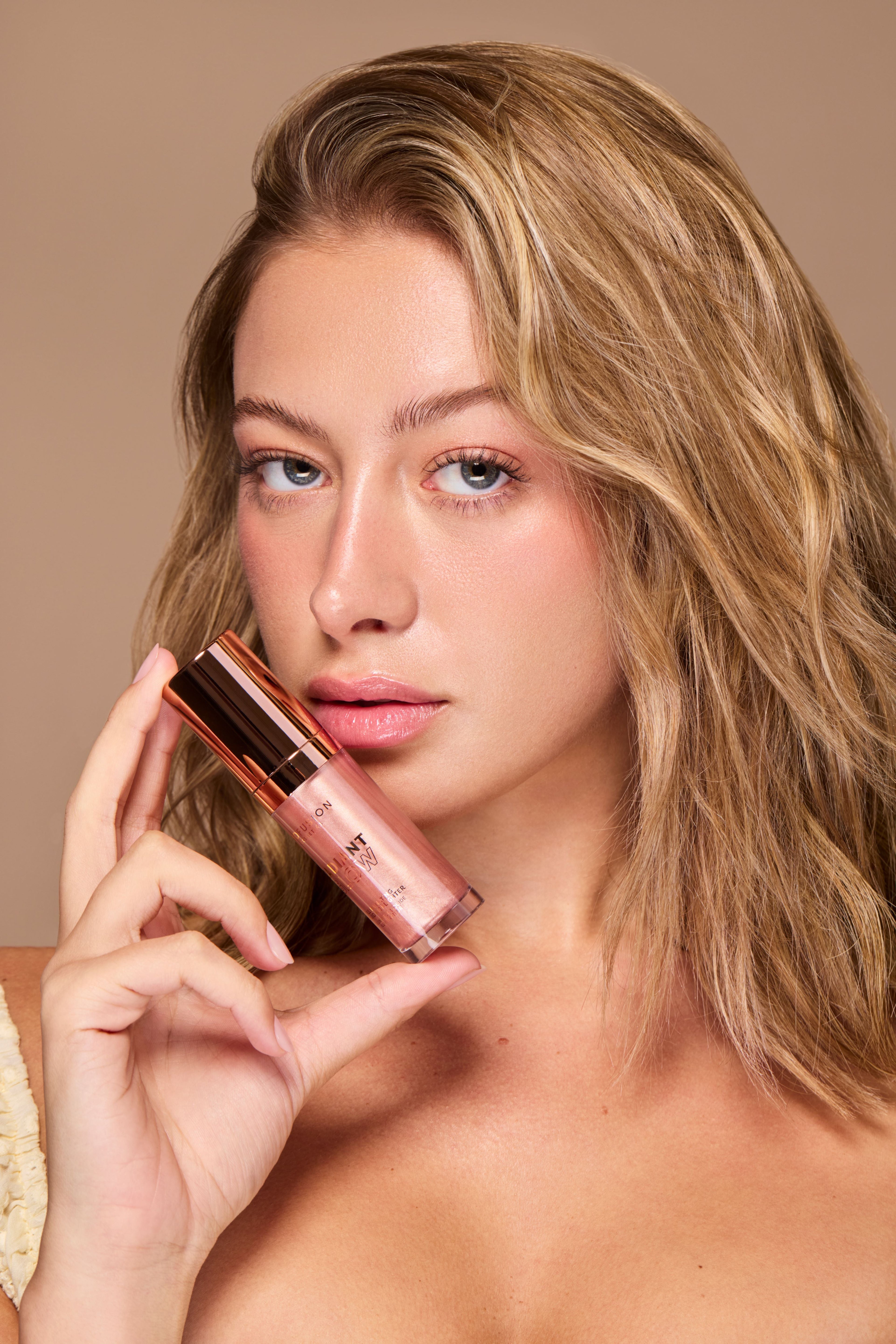 Profusion Cosmetics Radiant Glow illuminating liquid highlighter in champagne shade, showcasing its smooth, luminous texture.