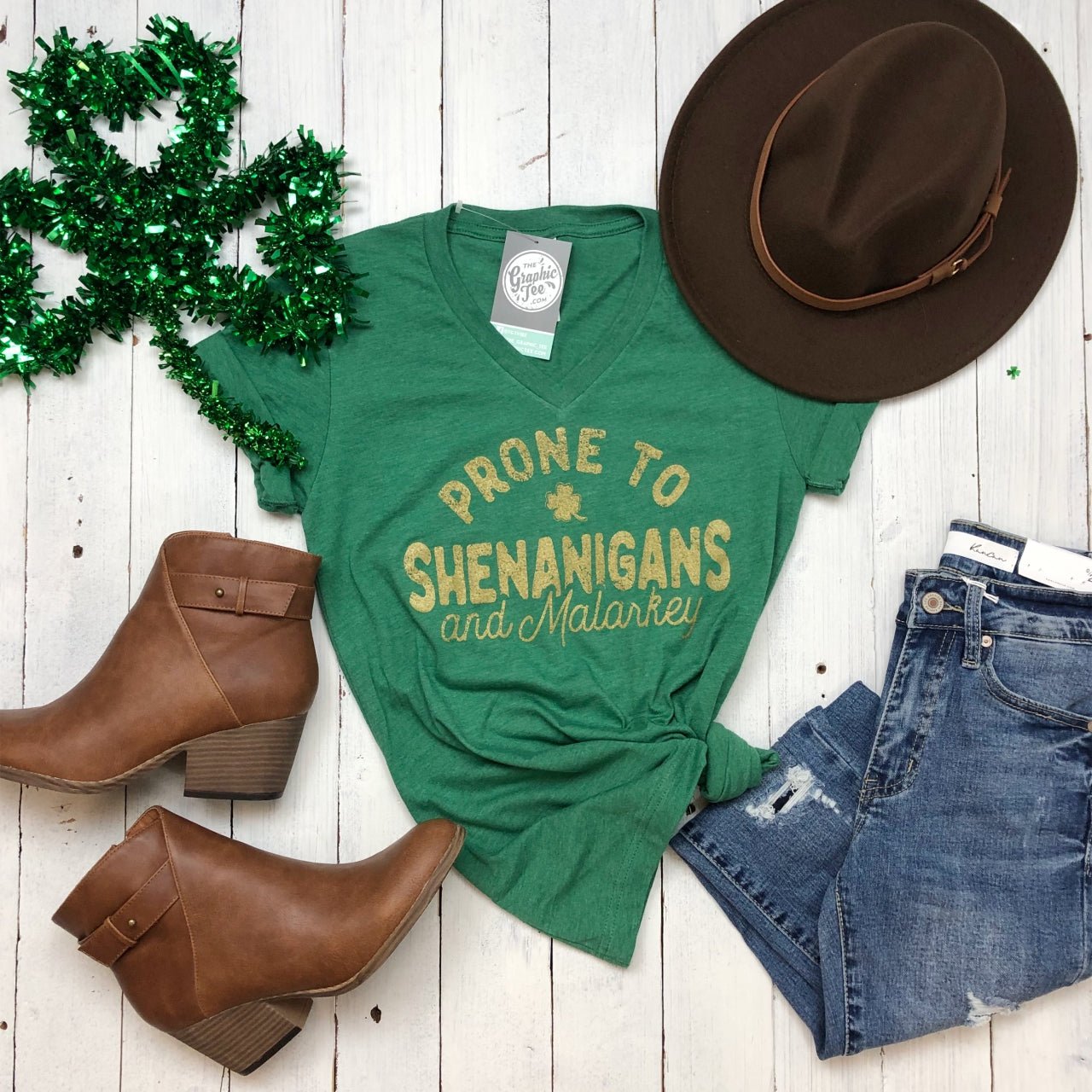 Heather green V-neck graphic tee with playful "Prone To Shenanigans And Malarkey" print by The Graphic Tee.