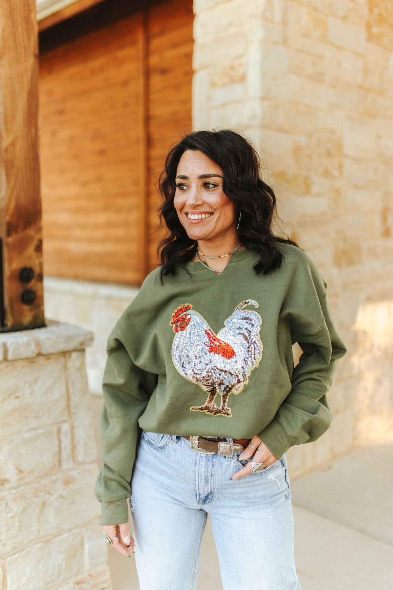 Wild Junkie rooster sequin V-neck sweatshirt featuring a colorful rooster graphic and sparkling sequin details.