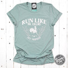 Bright graphic short sleeve tee by The Graphic Tee featuring "Run Like Mr. Collins Just Proposed" design on soft fabric.