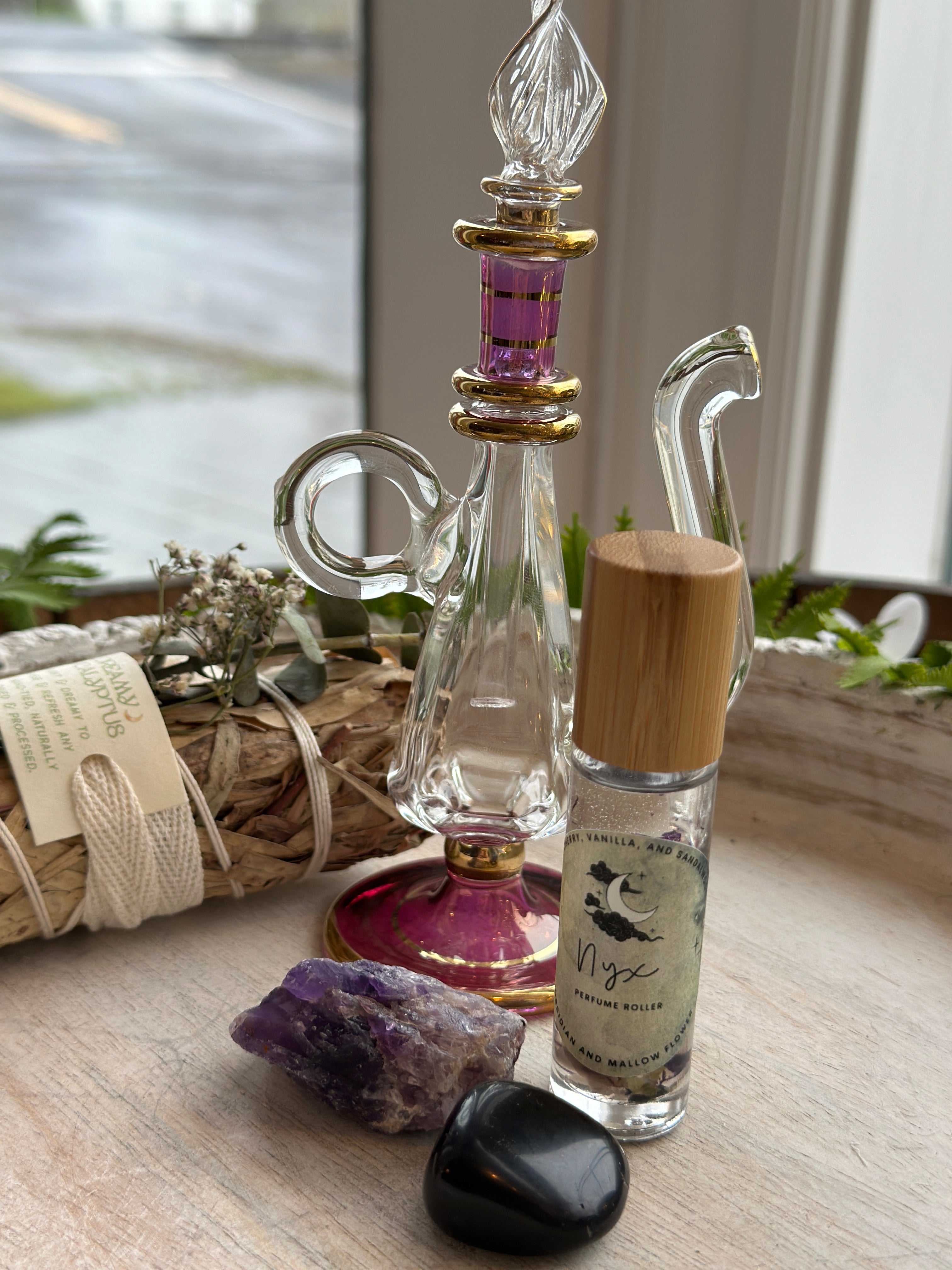 Sage & Stone Apothecary Goddess Perfume Roller, a body care product with a sleek glass rollerball for easy application.