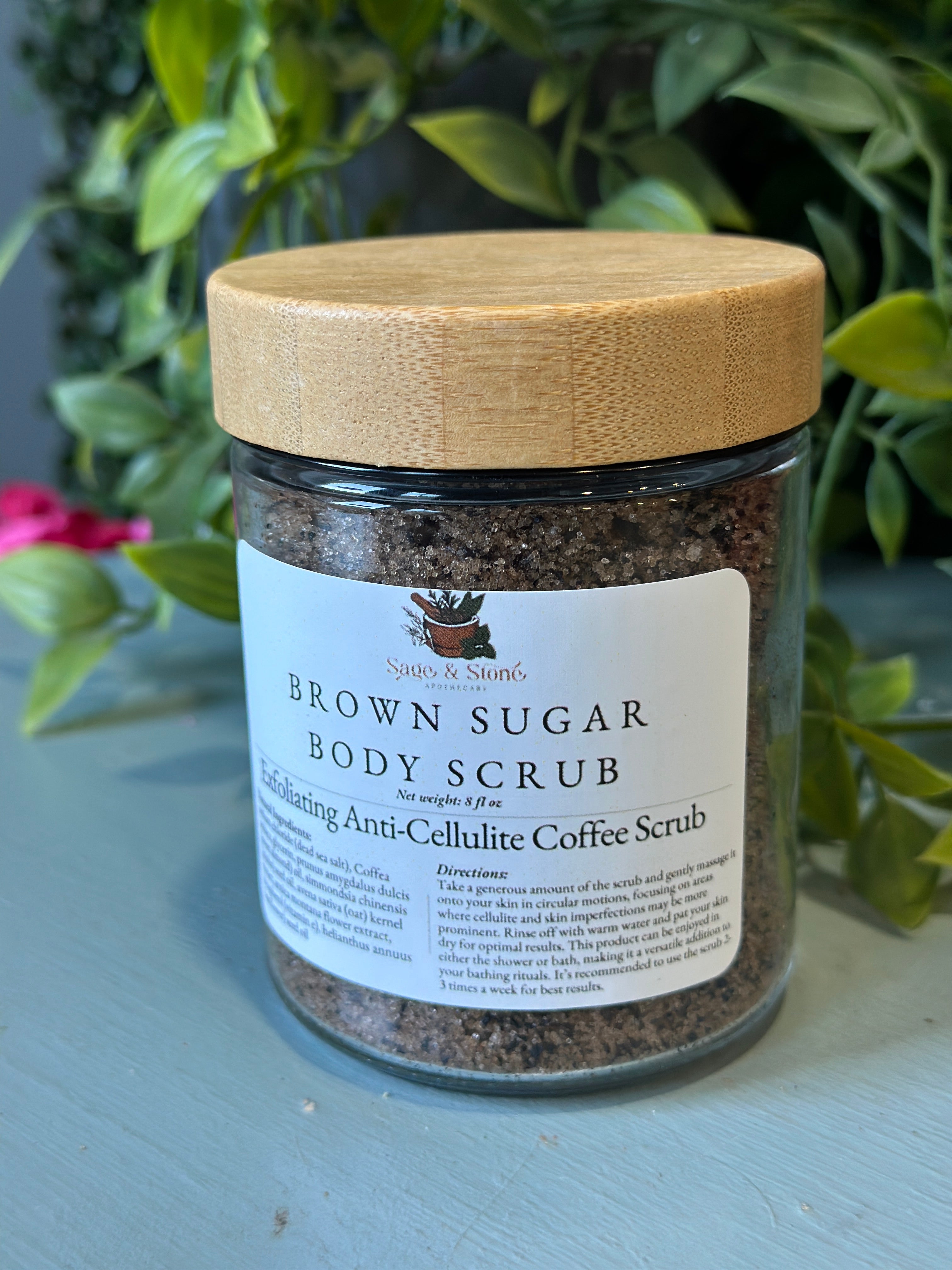 Sage & Stone Apothecary exfoliating anti-cellulite coffee scrub in a jar, showing the textured coffee scrub for body care and wellness.