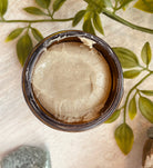 Sage & Stone Apothecary Calcium Bentonite Clay Mask for body care and wellness, showing the clay mask in a natural setting.
