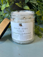 Exfoliating chamomile flower scrub in a jar from Sage & Stone Apothecary, showing the natural textured scrub with chamomile flowers.