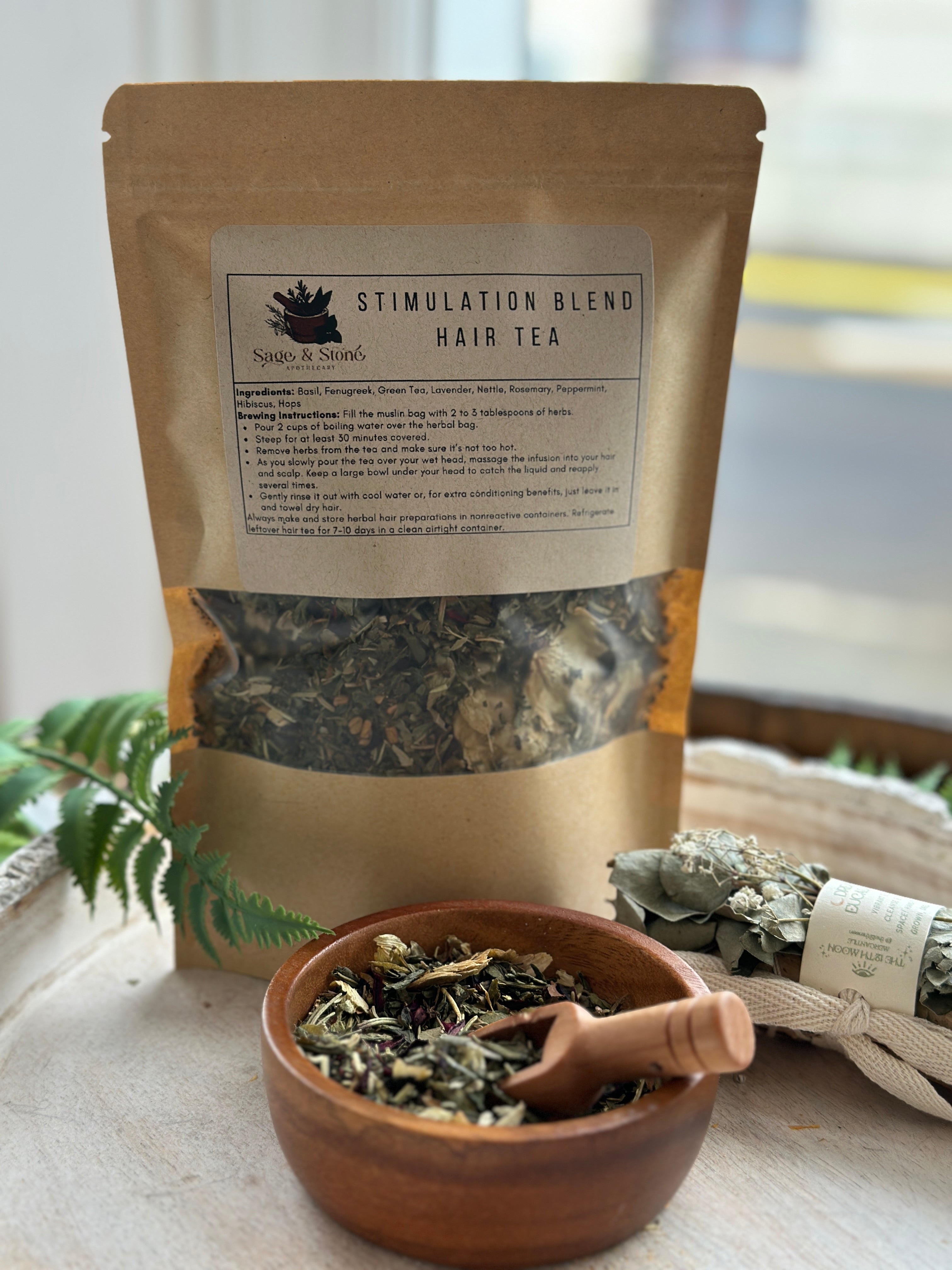 Sage & Stone Apothecary Hair Stimulation Tea Blend in a glass jar with a scoop, featuring dried herbs and botanicals for hair wellness.