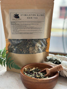 Herbal hair stimulation tea blend in a glass jar, featuring dried herbs and botanicals for hair and scalp wellness by Sage & Stone Apothecary.