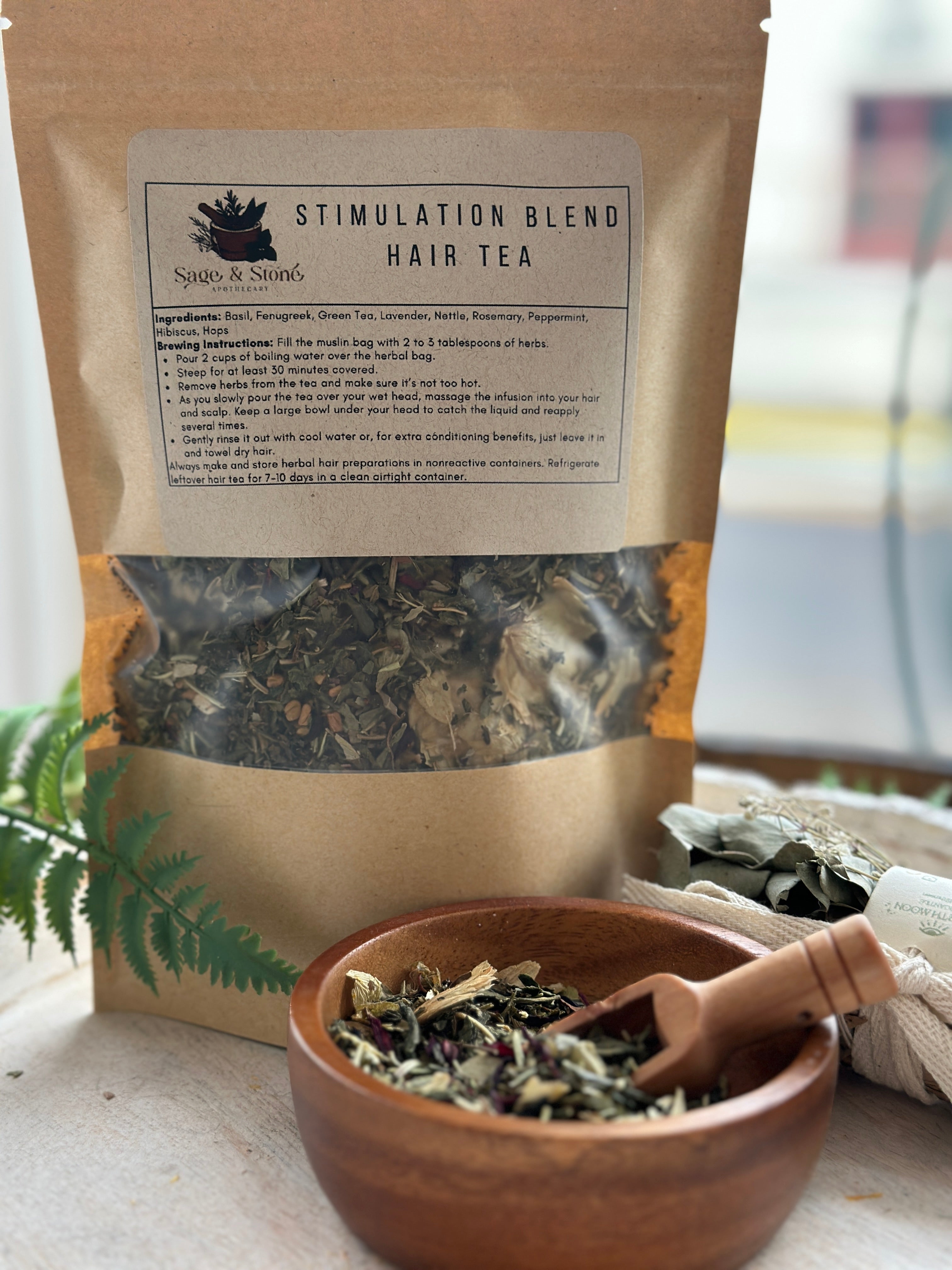 Herbal hair stimulation tea blend in a glass jar, featuring dried herbs and botanicals for hair and scalp wellness by Sage & Stone Apothecary.