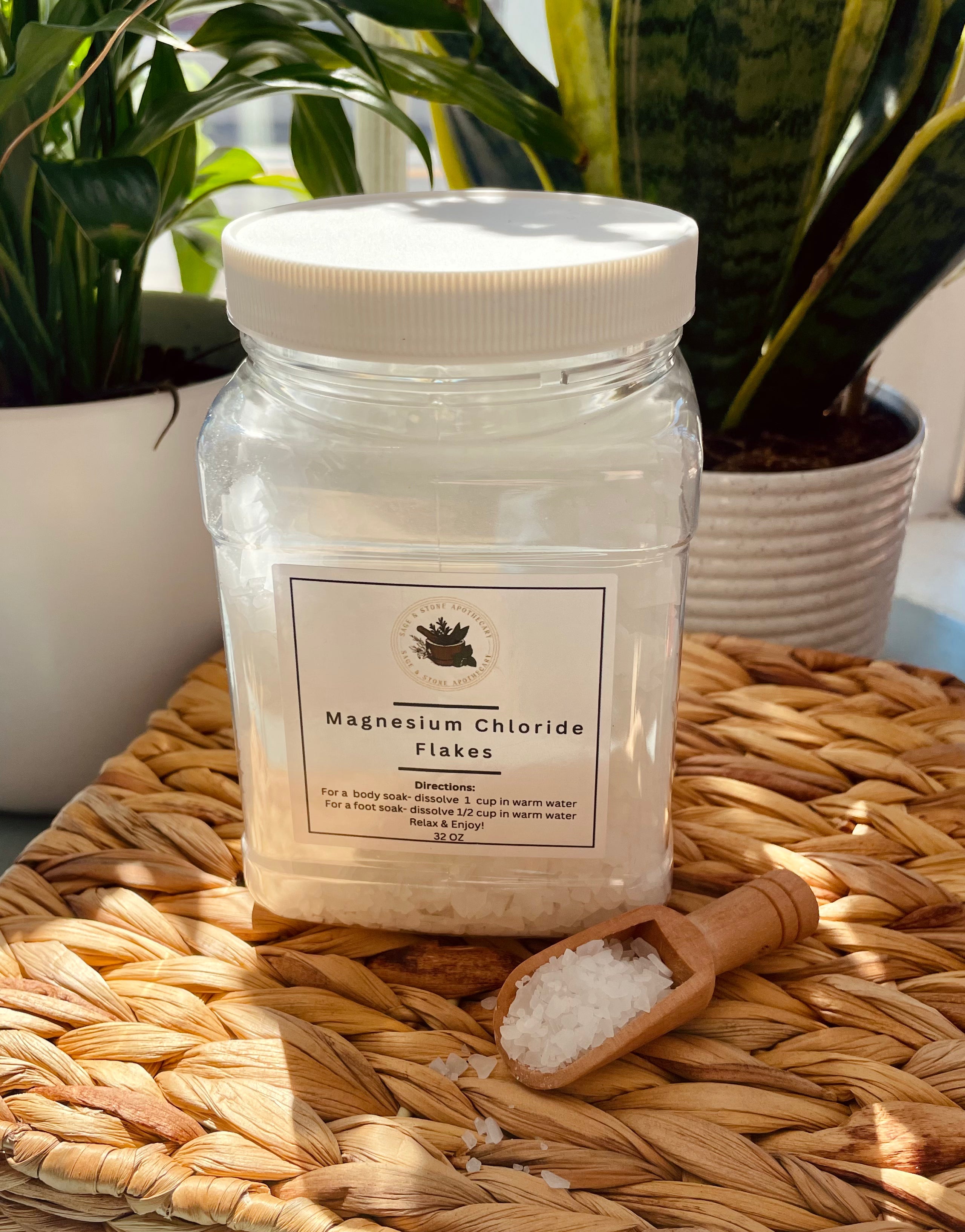 Sage & Stone Apothecary Magnesium Chloride Flakes for body care and wellness, shown in a clear, open container with flakes visible