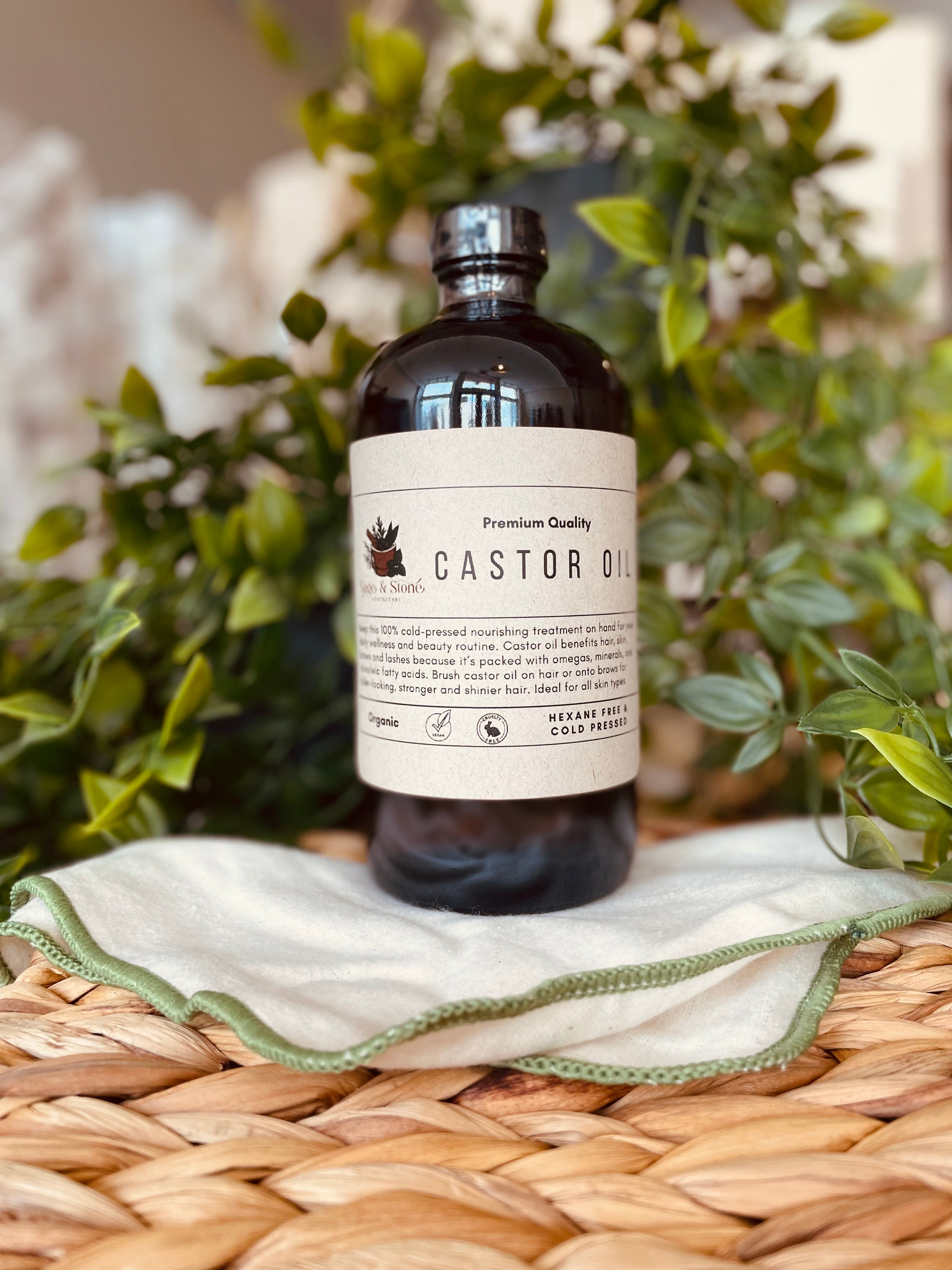 Organic cold pressed castor oil in a glass bottle from Sage & Stone Apothecary, ideal for body care and wellness routines.