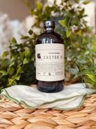 Organic cold pressed castor oil in a glass bottle from Sage & Stone Apothecary, ideal for body care and wellness routines.