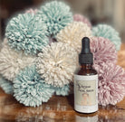 Rose Hip Facial Serum from Sage & Stone Apothecary, natural body care and wellness product with a sleek glass bottle and dropper.