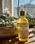 Sage & Stone Apothecary calendula body oil bottle with dropper, natural skincare product for soothing skin.